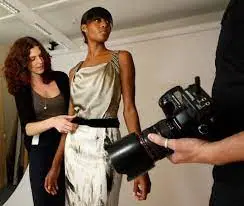fashion stylist styling model on a shoot 